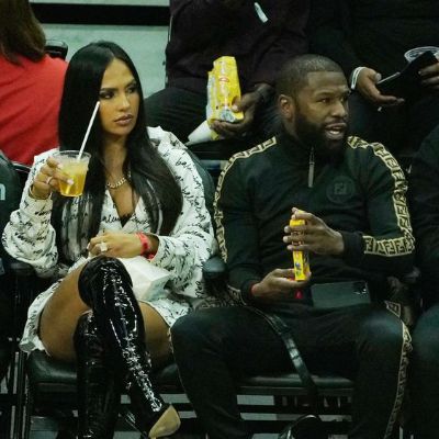Nabila and Mayweather enjoying the NBA game with drinks and snacks in their hand.